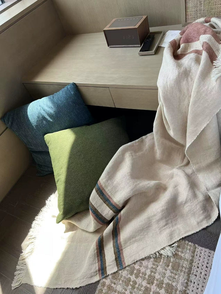 Cozy Striped Linen Throw Blanket, multicolor, with fringed edges, adds warmth to home decor.