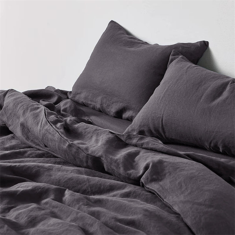 Dark grey natural linen bedding set with two pillows, soft and comfortable.