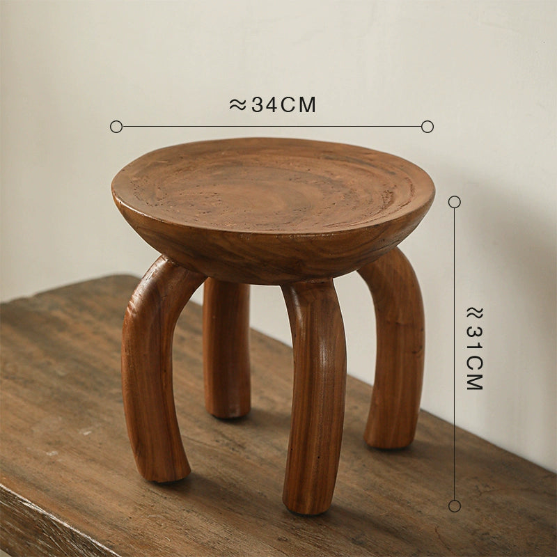 Ethnic style wooden side table: round coffee table with curved legs, natural wood finish.