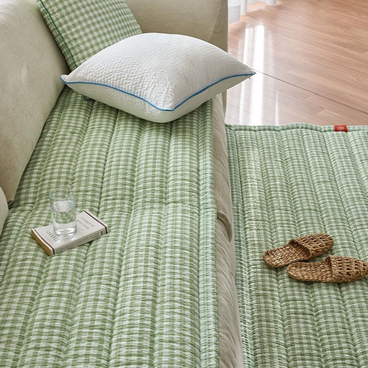 Green gingham sofa protector and rug set.  Quilted design, matching rug, light beige sofa.  Cozy living room decor.
