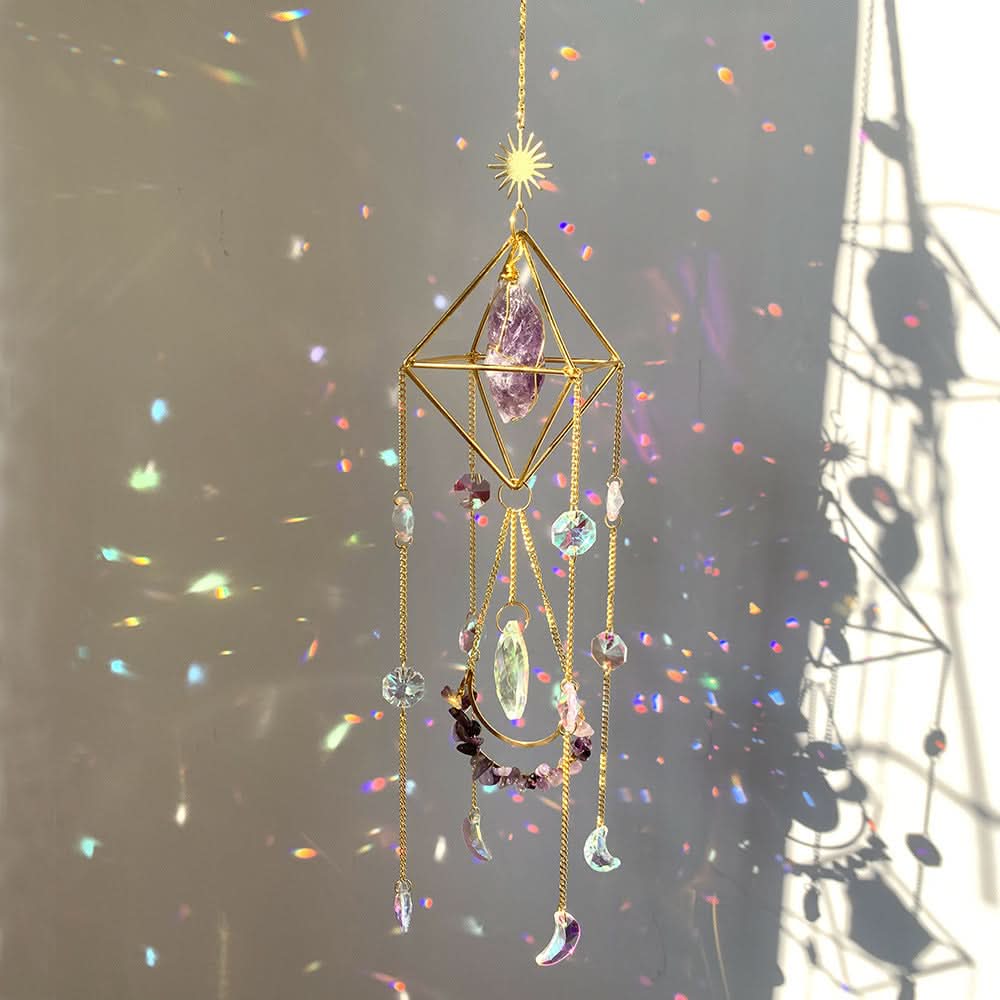Crystal diamond sun catcher with amethyst, prisms, and moon charms casting colorful light reflections.