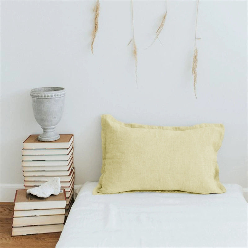 Pale yellow linen pillow case with frills, part of elegant home decor.