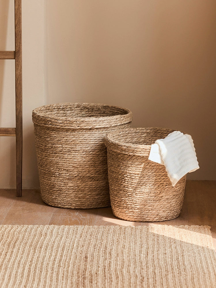 Natural rattan storage baskets, set of 2, in a cozy home setting with a white towel.