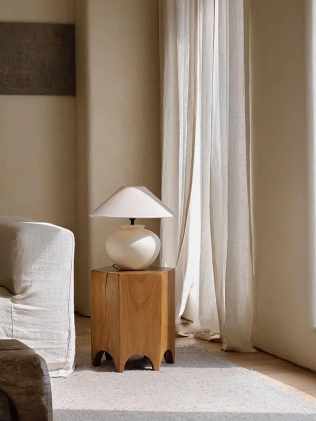 Wooden hexagonal side table with minimalist design, featuring a white lamp on top.