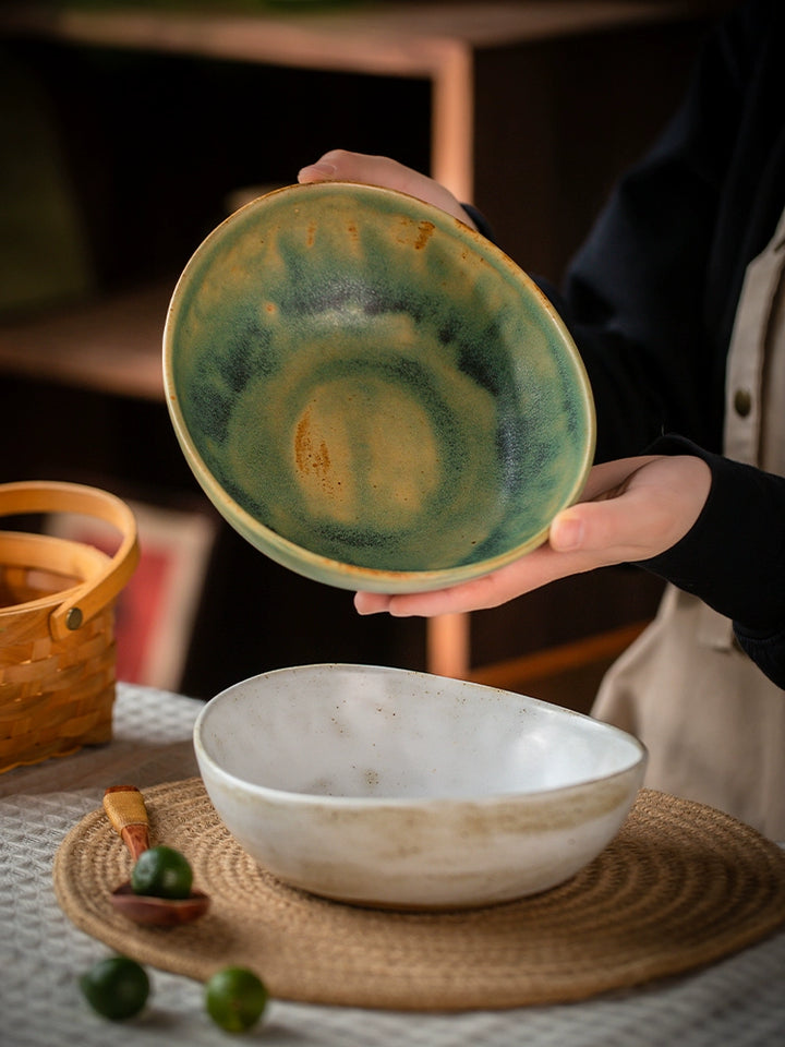 Two hand-painted ceramic bowls, rustic & stylish.  One teal-green, the other off-white with a speckled glaze. Oval shape.