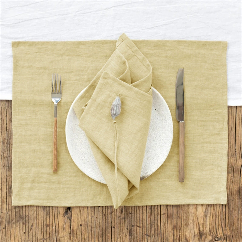 Elegant Linen Table Napkins in sage green, set of 4, folded with dried flower accent on plate.