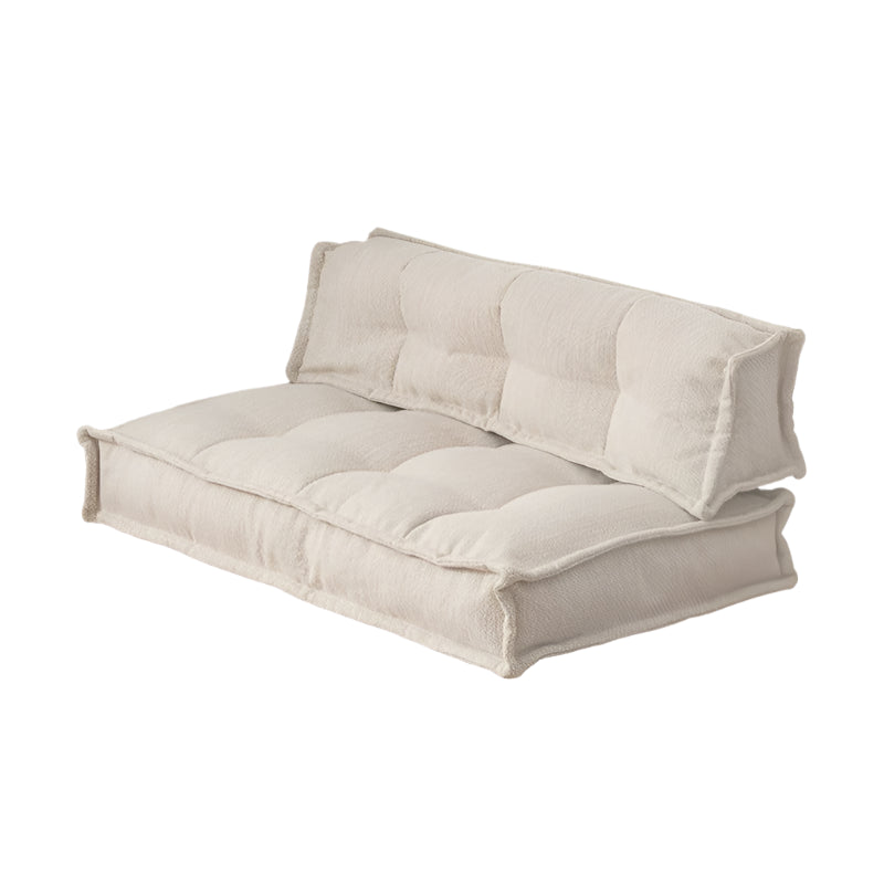 Beige modular sofa with tufted cushions.  Comfortable, contemporary design.