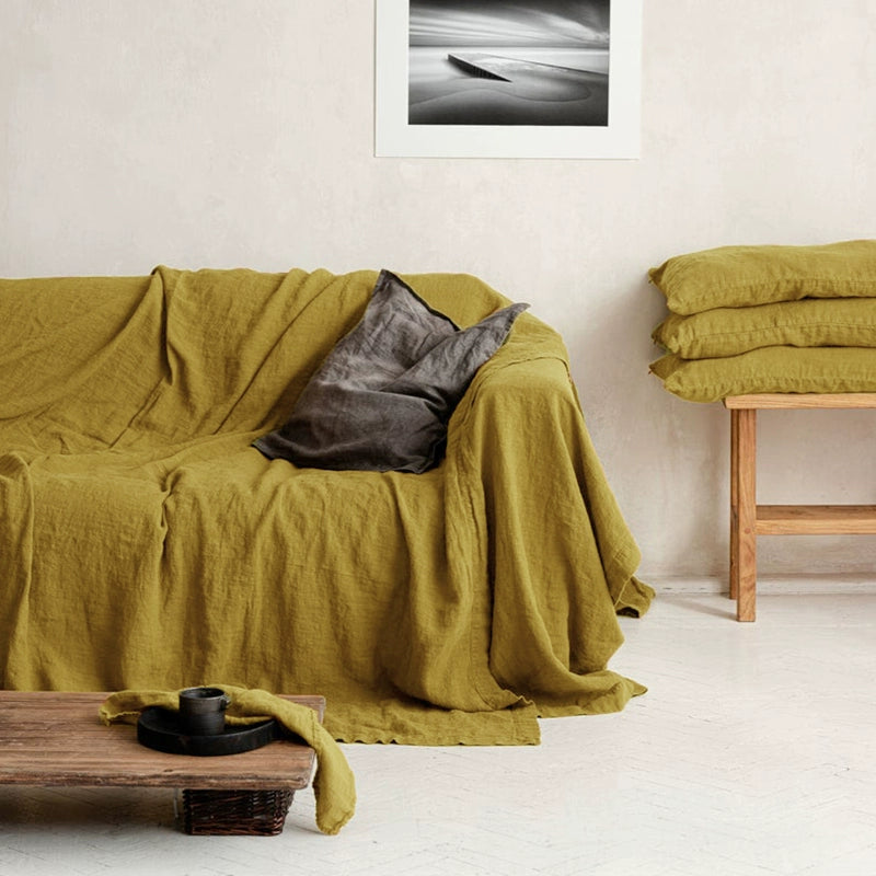 Mustard Yellow Linen Sofa Throw Blanket with gray pillow on a sofa, cozy living room decor.