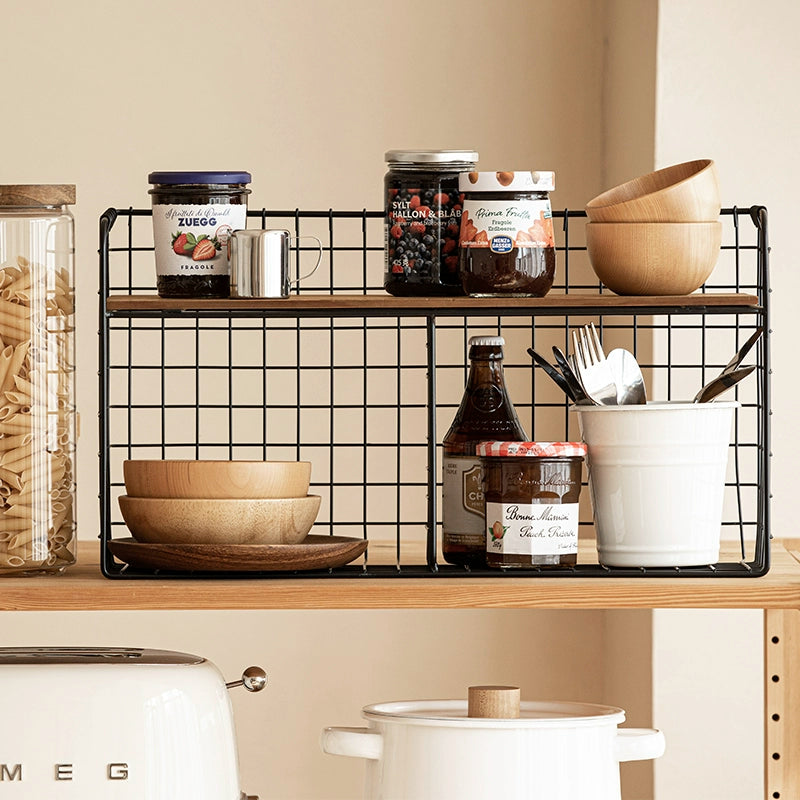 Black metal wire wall shelf with wooden top, double-tiered kitchen storage organizer holds jars, bowls, and utensils.