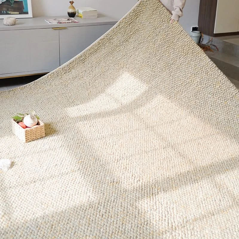 Luxurious wool rug in a neutral design, displaying a textured weave in a modern living room setting.