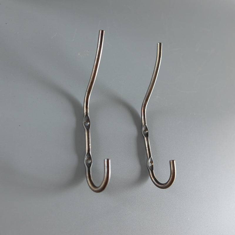 Two metal wall hooks.