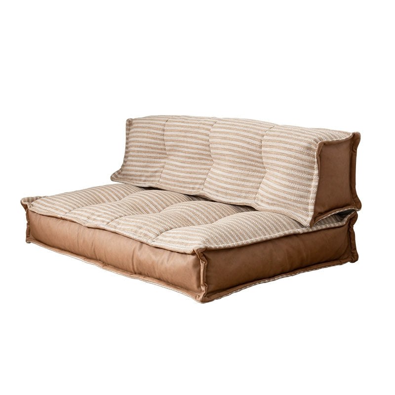 Modern minimalist floor sofa with brown leather and beige striped fabric, comfortable seating
