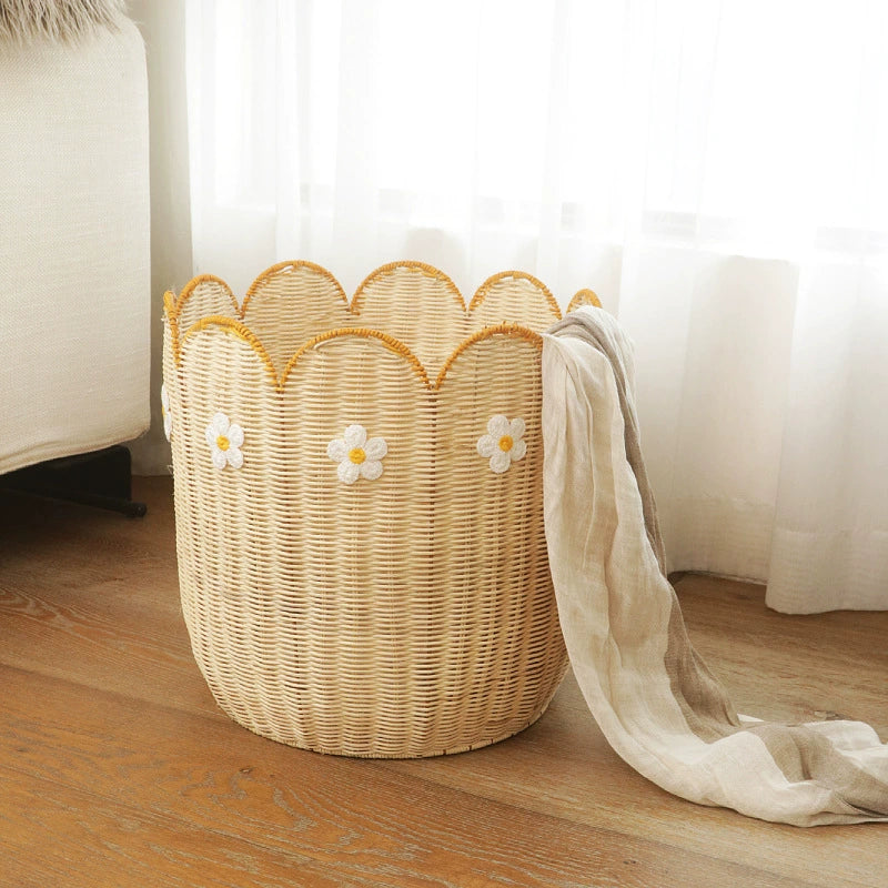 Natural rattan woven basket with scalloped edge and yellow daisy embroidery.  Stylish storage.