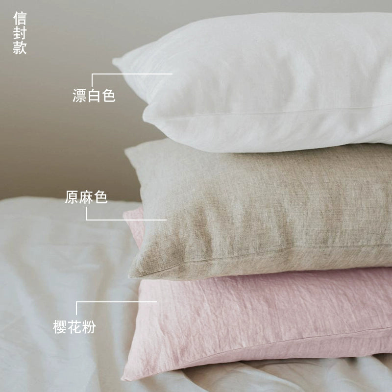 Elegant Linen Pillow Cases with Frills in white, natural, and pink linen on a bed.