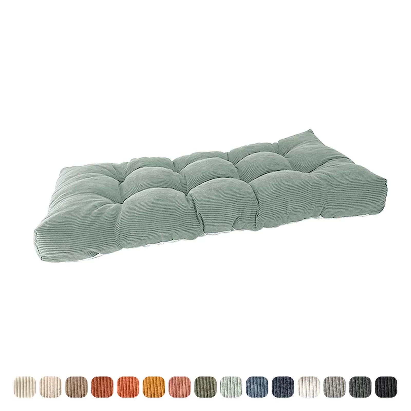 Plush, tufted bench cushion in sage green, angled view showcasing the soft filling.
