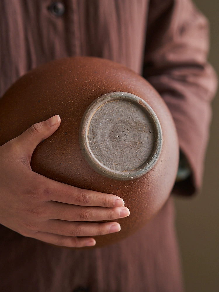 Rustic brown handmade pottery vase, 23cm tall, held by hands.  Unique texture and glaze.  Handcrafted.