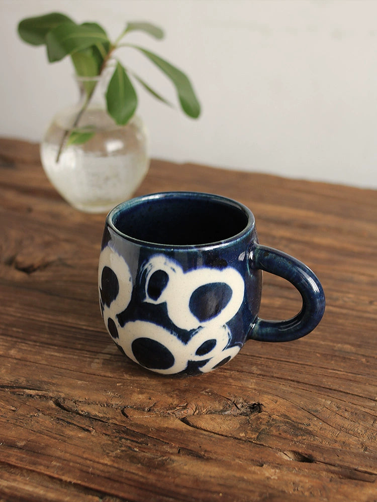 Blue and white ceramic coffee mug with a handle