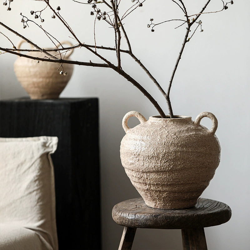 Rustic Ceramic Vase with Handles, decorative pottery in beige, handcrafted home decor on wooden stool