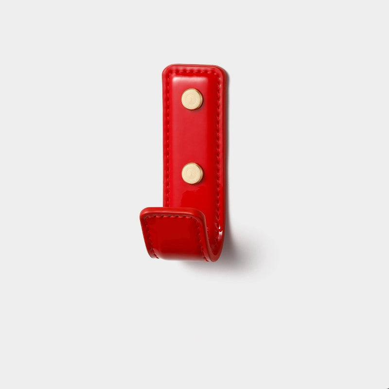 Red patent leather wall hook with gold fasteners, part of Dopamine Decor Colors collection.