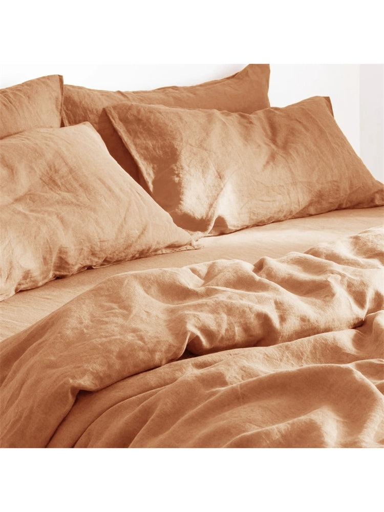 Natural linen bedding set in a soft terracotta color, featuring comfortable, textured fabric.