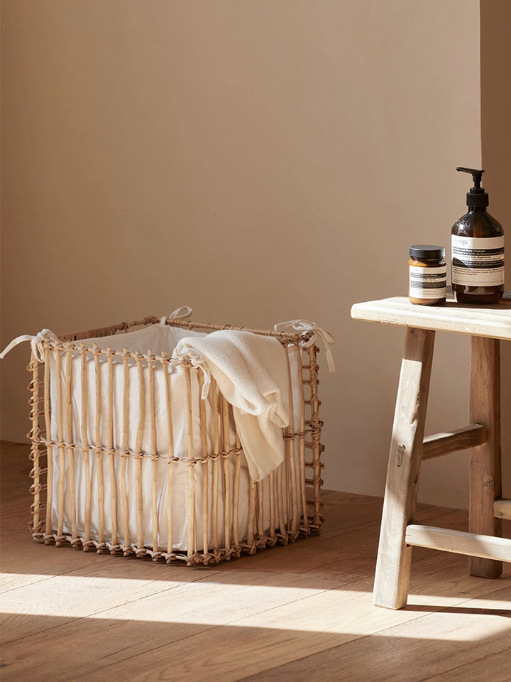 Light beige square rattan storage basket with cream linen lining. Woven design, perfect for home organization.