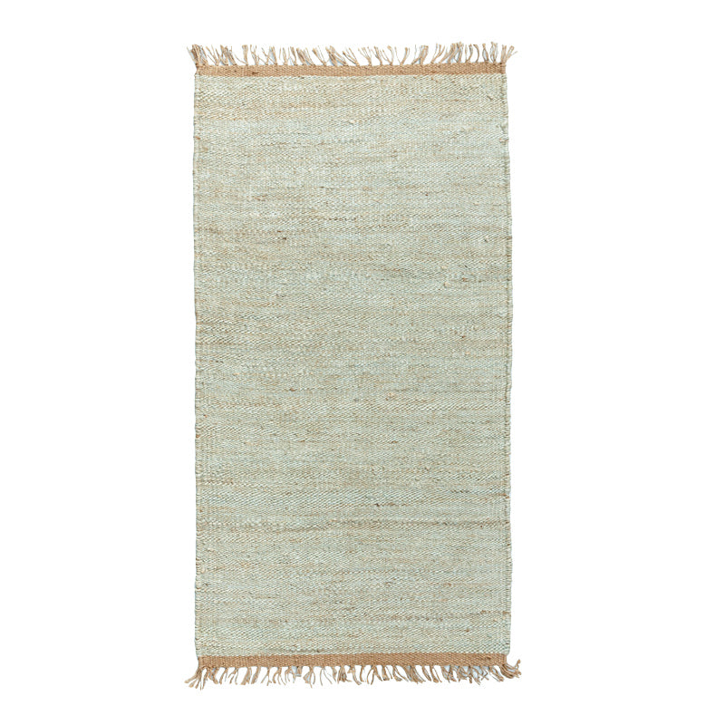 Light sage green rug with beige fringe.