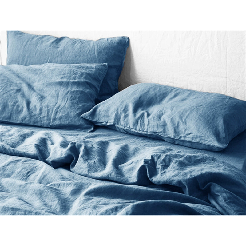 Blue natural linen bedding set on a bed, soft & comfortable home decor.