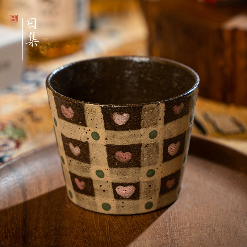 Traditional Japanese hand-painted ceramic tea cup with pink hearts on a checkered background, decorative gift.