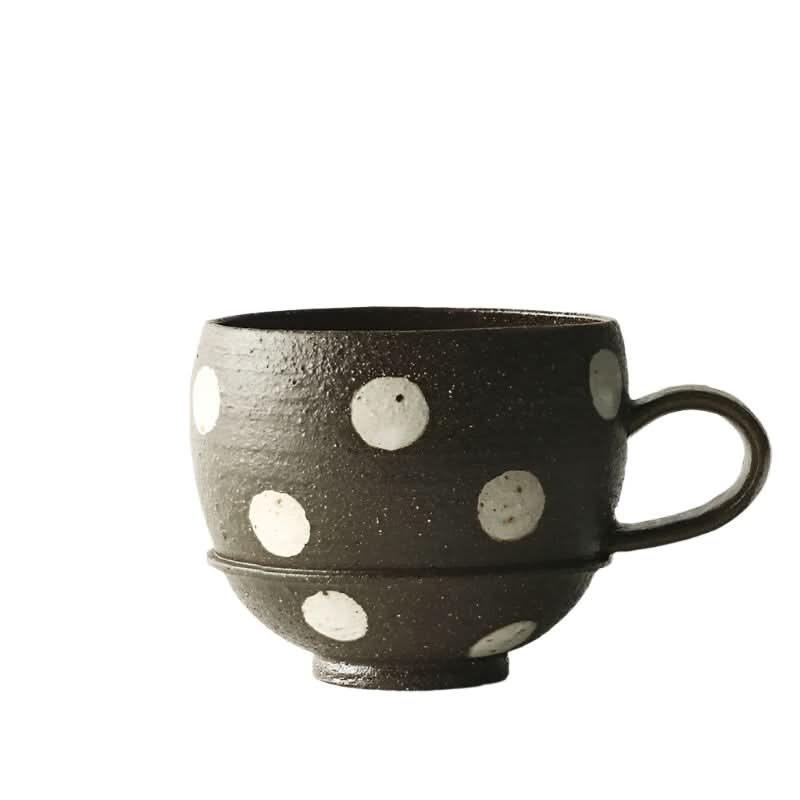Rustic ceramic coffee cup with white polka dots, part of unique handcrafted home decor.