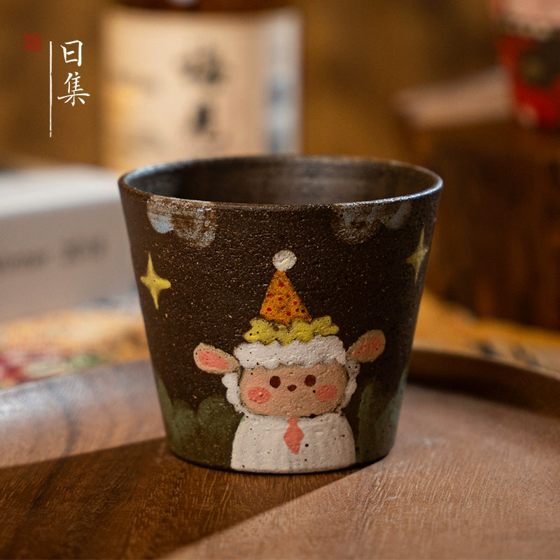 Brown ceramic tea cup with hand-painted sheep in party hat. Decorative gift.
