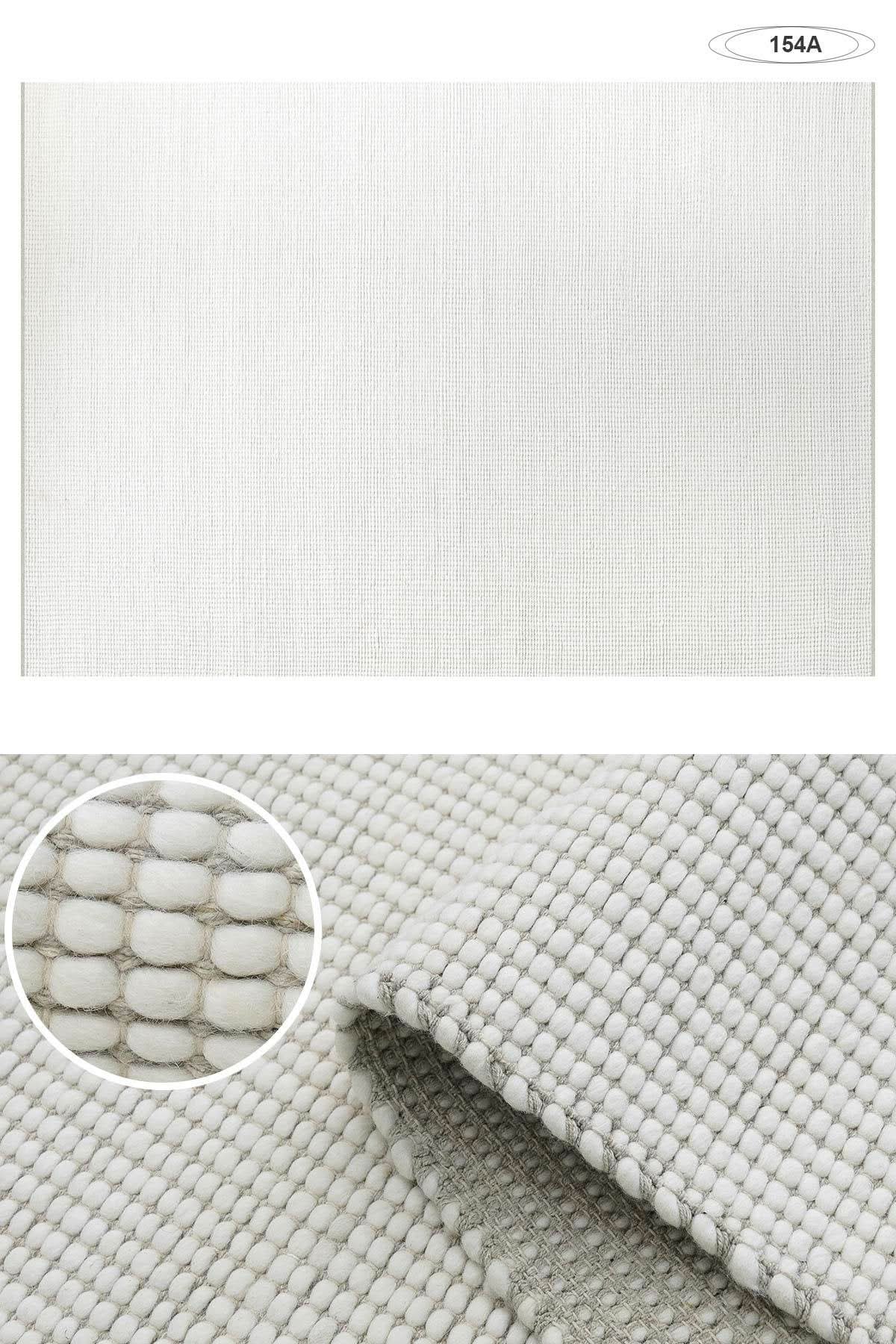 Close-up of Wool Handwoven Cream Rug, showing textured, looped weave and soft wool fibers.