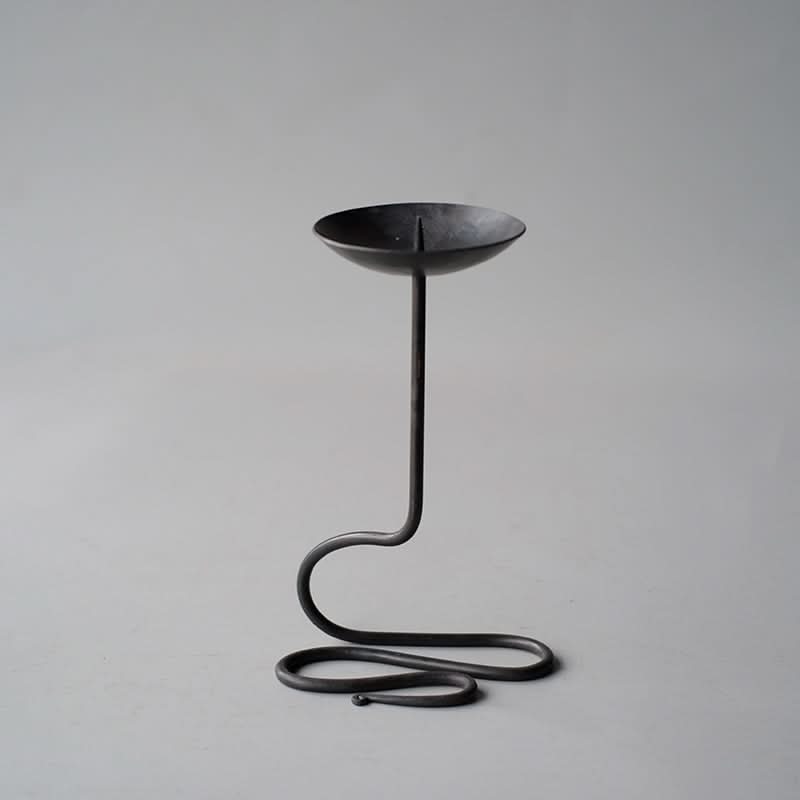 Black Metal Curved Candle Holder - Elegant candle stand with unique coiled base.