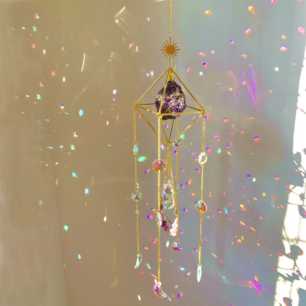 Hanging crystal diamond sun catcher with gold geometric frame, purple crystal, and colorful faceted prisms creating rainbo...
