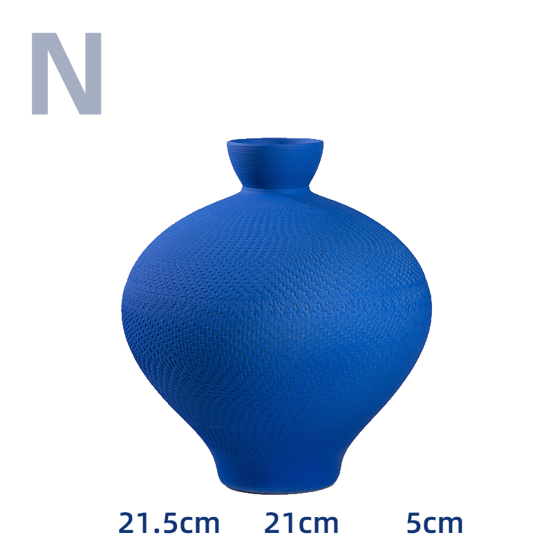 Vibrant blue textured vase with a unique rounded shape, perfect home decor accent.