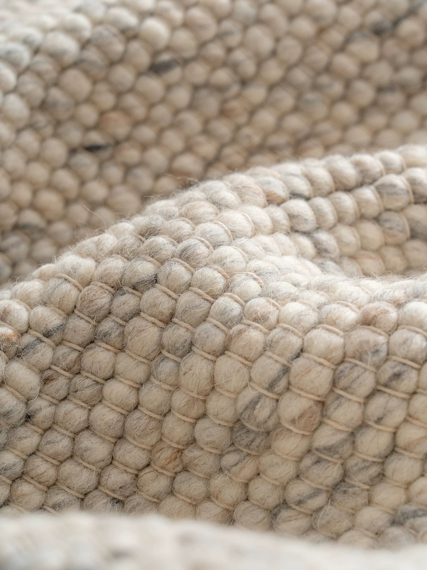 Close-up of thick textured wool rug with pebble weave detail