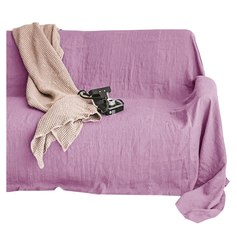 Lavender linen sofa throw blanket draped on a couch with a knit throw and vintage camera.