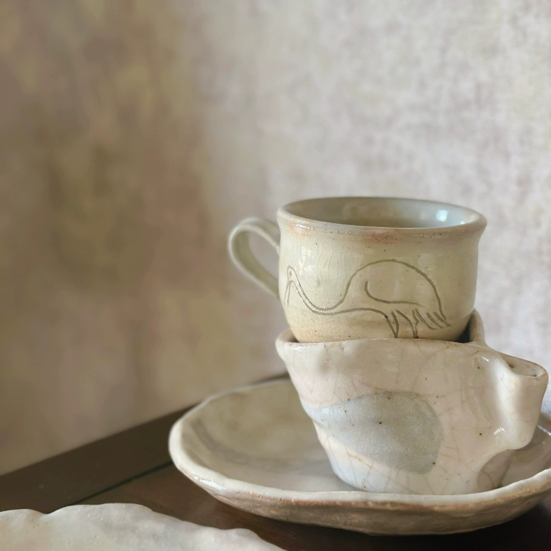Hand-thrown Japanese vintage teacup & saucer set in cream ceramic with bird motif.