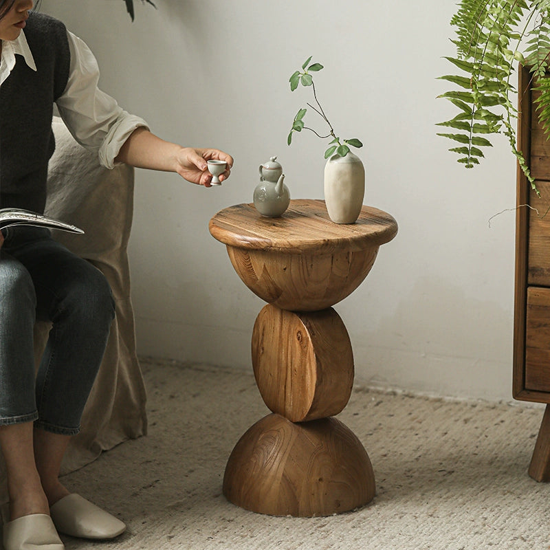 Light brown wooden round side table with stacked design.  Natural wood grain.  Perfect for displaying small decor.
