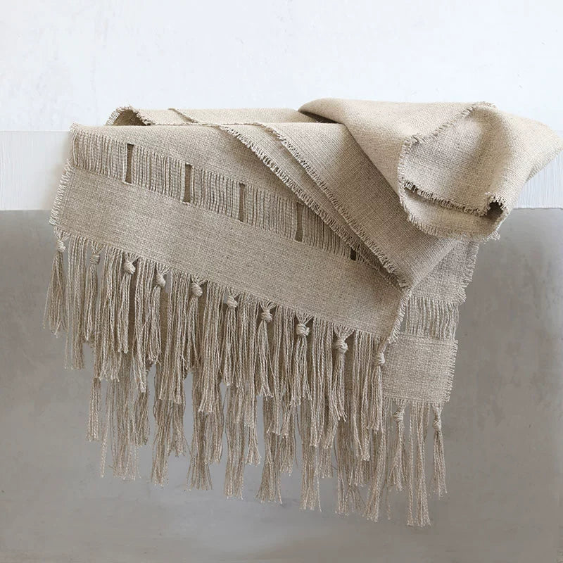 Beige linen table runner with tassels, rustic woven tablecloth detail