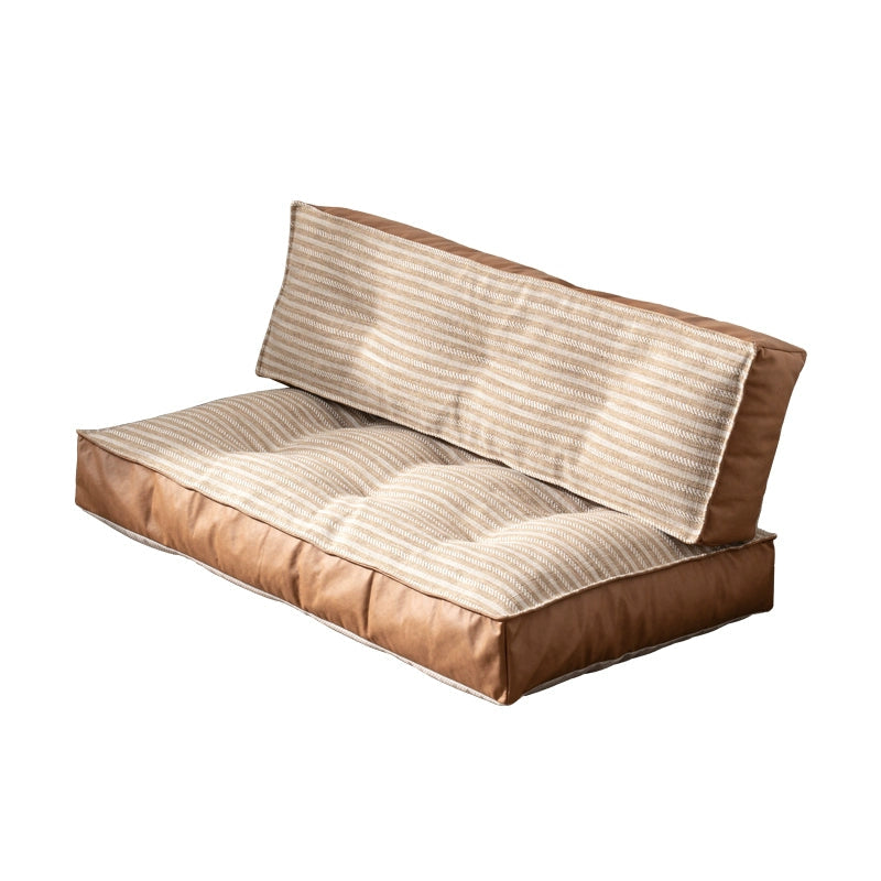 Modern minimalist floor sofa with brown leather and striped fabric seating area.