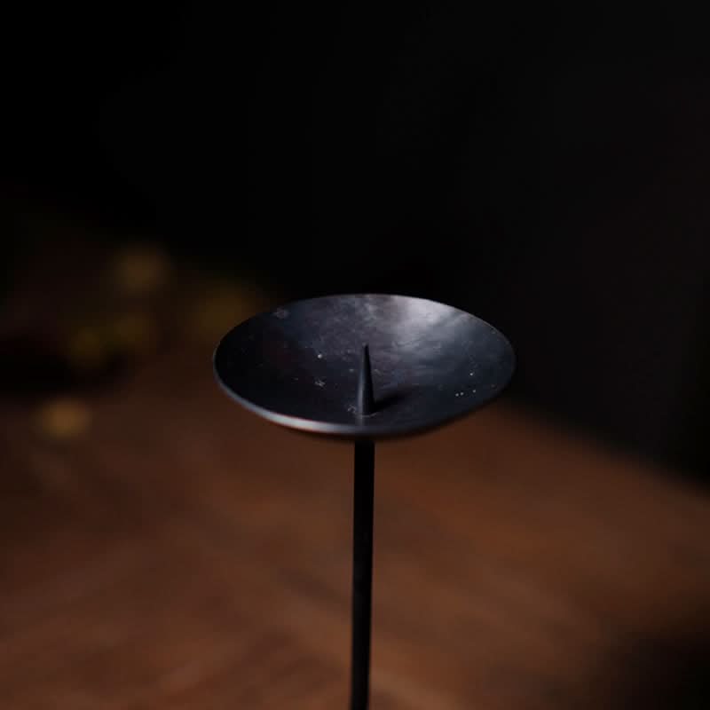 Black Metal Curved Candle Holder, elegant candle stand on wooden surface.