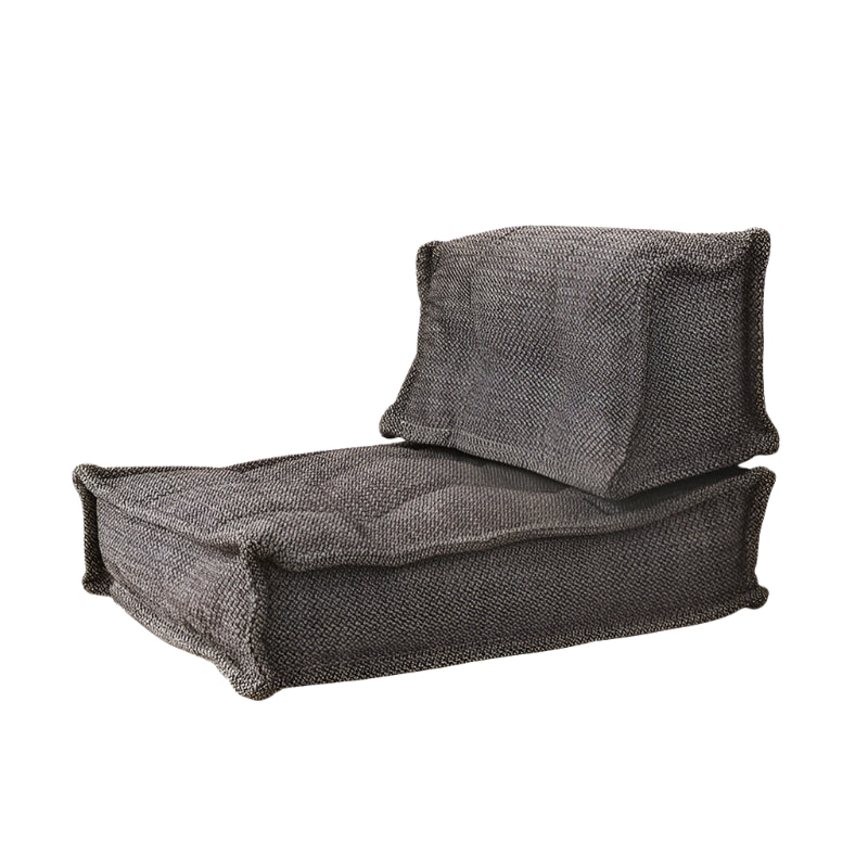 Beige modular sofa with tufted cushions,  fabric upholstery.
