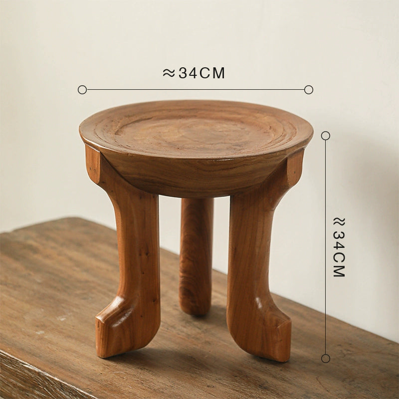 Ethnic style wooden side table, round coffee table with curved legs, ~34cm diameter.