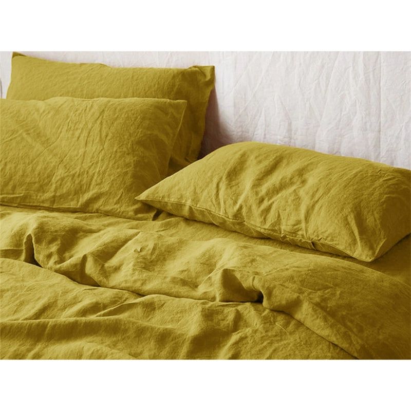 Soft mustard yellow natural linen bedding set on a white background.