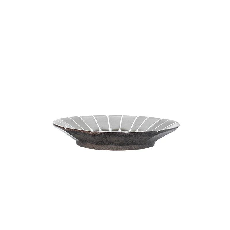 Overhead view of a 5.5-inch brown ceramic bowl with green interior and white stripes, 14.2cm.