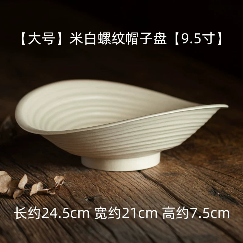 Large 9.5-inch rice white spiral oval platter with ridged texture on a wooden surface.