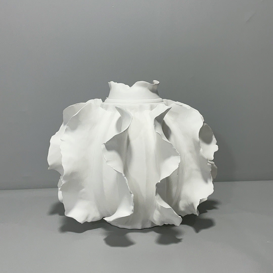 Elegant white ceramic vase with ruffled design