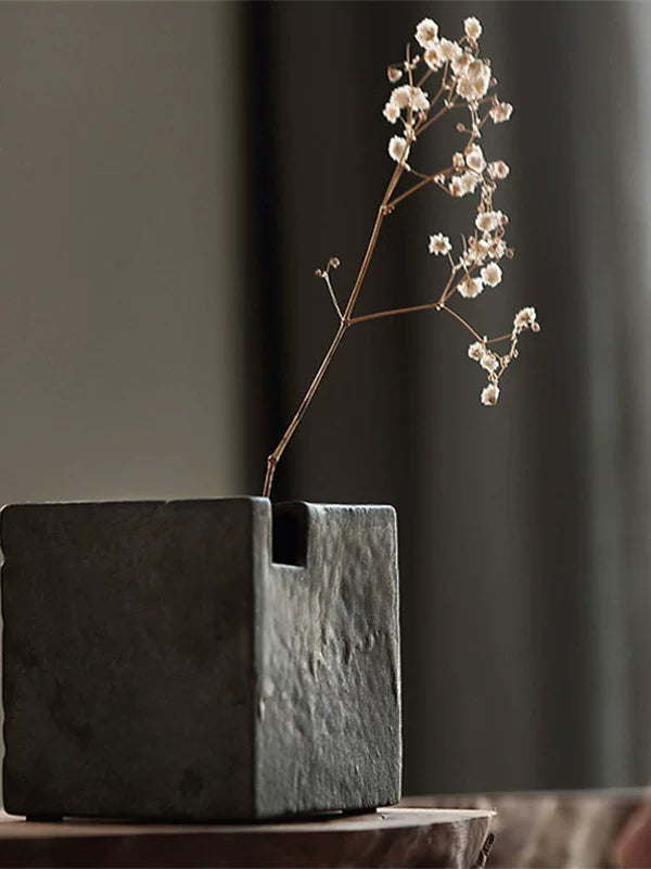 Handmade ceramic vase with a rustic stone texture and metallic micro-light glaze.