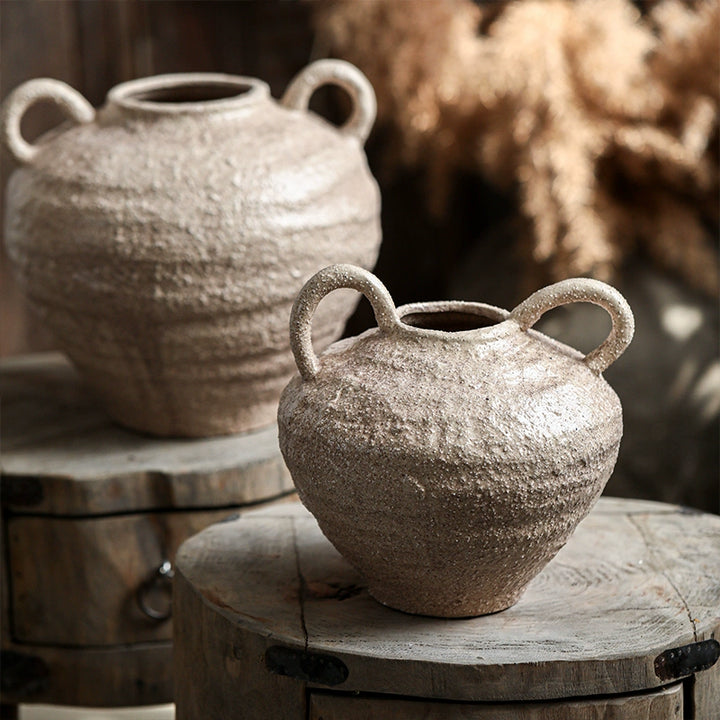 Rustic ceramic vase with textured light beige finish and two handles. Handcrafted pottery home decor.