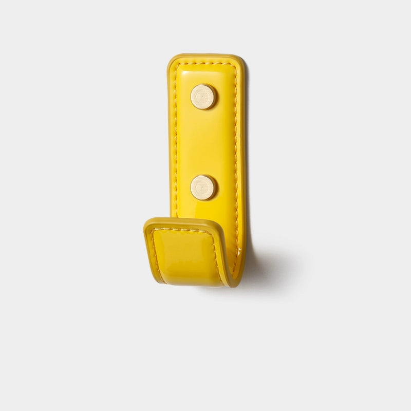 Bright yellow leather wall hook from Dopamine Decor Colors, shiny finish, brass hardware.